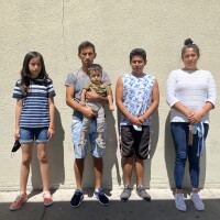  Rosa Viridiana Ceron Alpizar (far right) stands against a wall with her brother and children