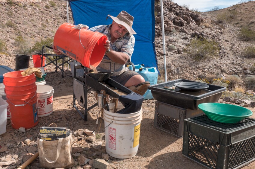 Steve Hartenstine operates a small, battery-powered sluice using recycled water at First Class Miner's Middle Camp claim located east of Joshua Tree National Park | Kim Stringfellow
