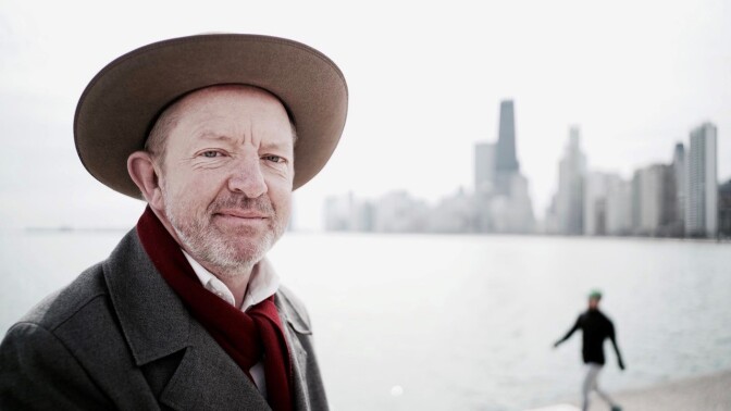 Jonathan Adams poses next to a body of water and a distant horizon line.