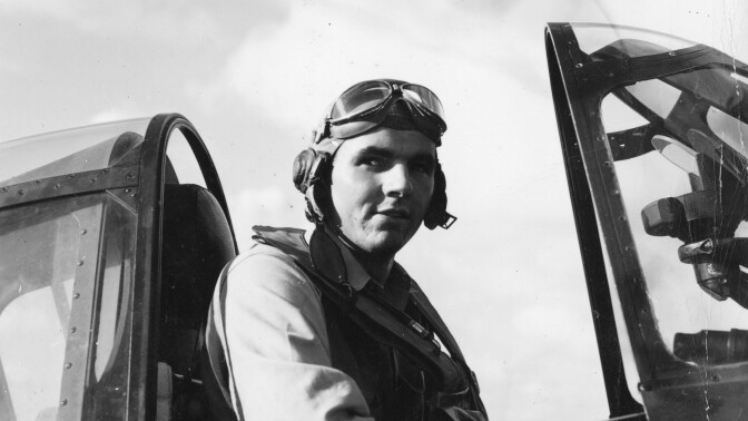 Jack Taylor seated in a Hellcat fighter jet.