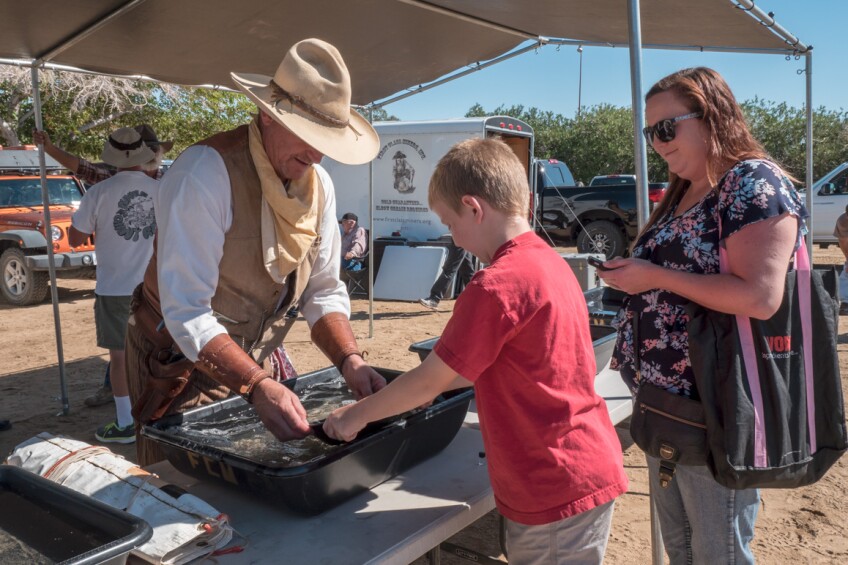 FCM's current Vice President Greg Herring shows a boy how to pan for gold at the annual Joshua Tree Gem & Mineral Show. | Kim Stringfellow