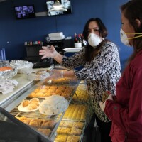 Kate Griendling, founder of Fueling the Fearless, collects donations with Aliki Eddy, owner of Aliki's Greek Tavern