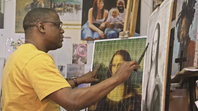 Aderbanji Alade analyzes Leonardo da Vinci's Mona Lisa using a grid in his art studio filled with images on the walls.